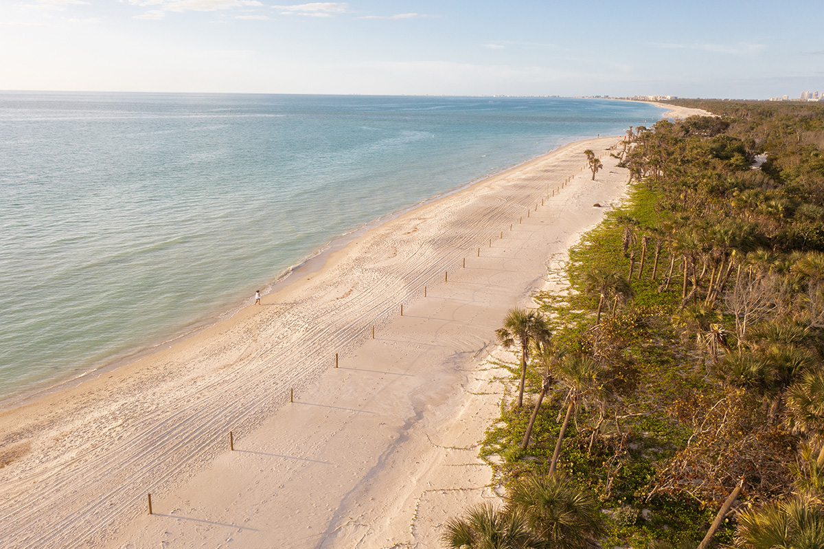 A view of the beach and dunes at Delnor-Wiggins Pass State Park in North Naples, Florida.