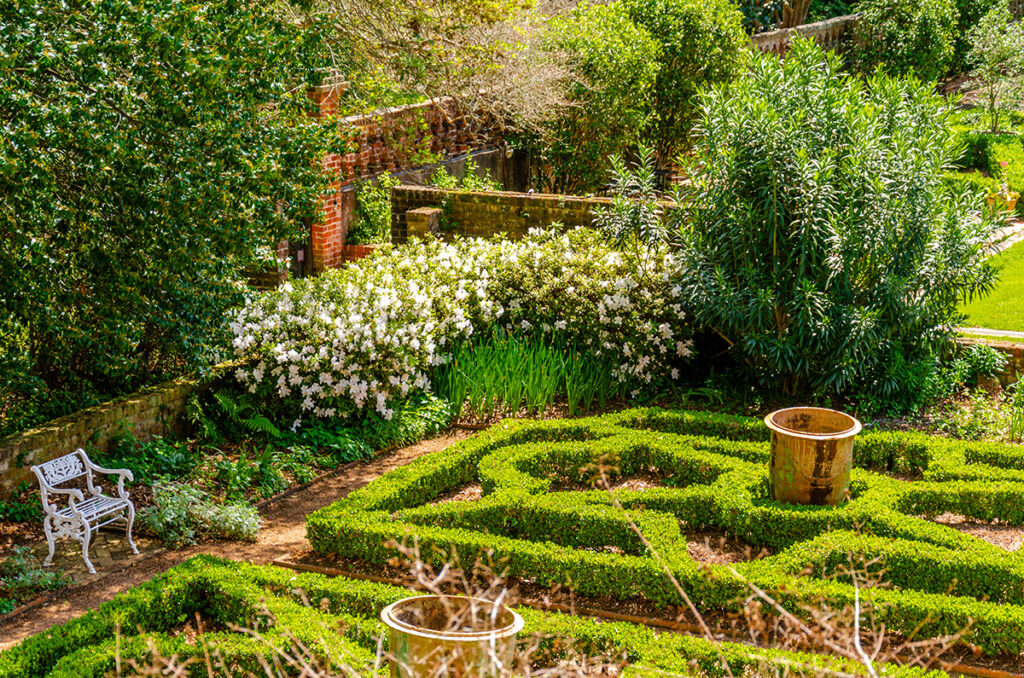 The formal Portico Garden at Longue Vue in New Orleans showcases a parterre and lush plantings of historic plants.